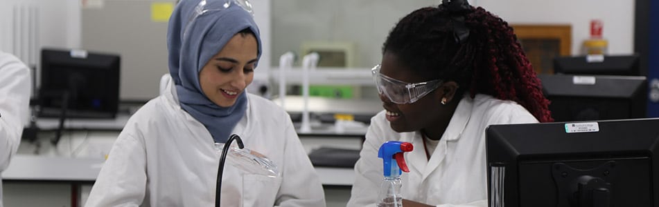 Students discussing ideas in science lab